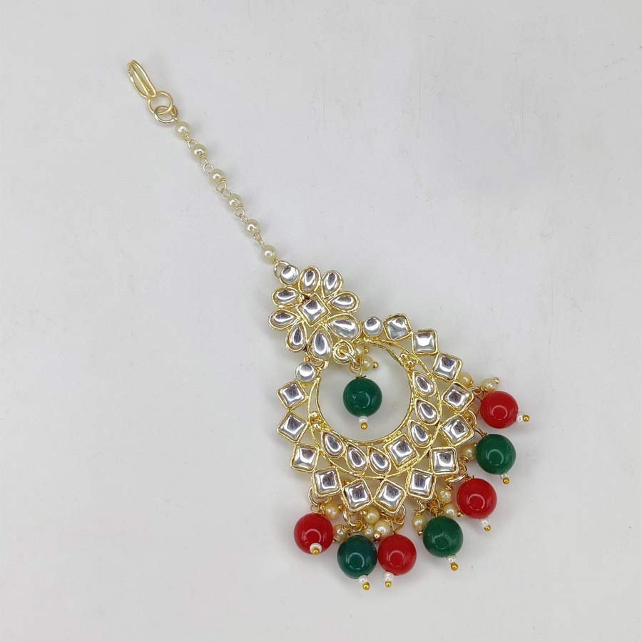Gold plated unique design Studded with Green and Red Kundan stones