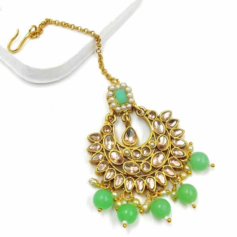 Mint colour wonderful classy traditional mang tikka form kayaa fashion for stylish women like you. It is wonderfully styled with stone and made form metal. This classy mang tikka has pearls beads droplets for stylish look. Buy now!