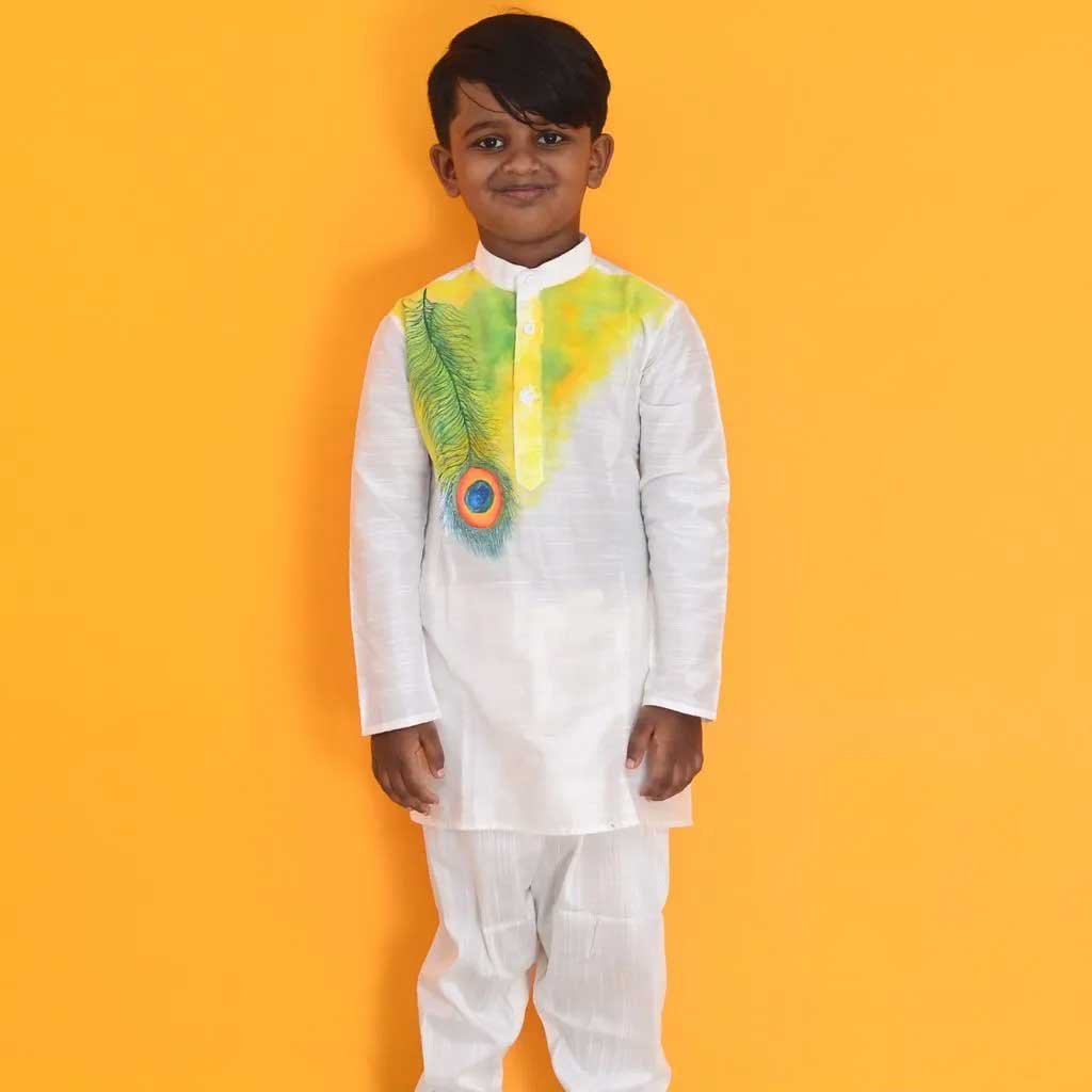 Rangoli !! Kids love to dash into the splash of colours. A yellow splash on white kurta with a beautiful hand painted Morpankh design for your little Kanha.