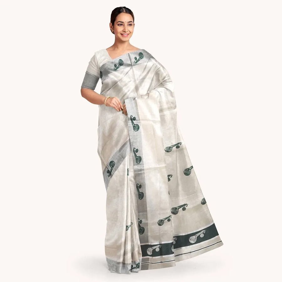Silver tissue sari with tribal folk print. Embrace a signature look with this muted shades of green and silver .