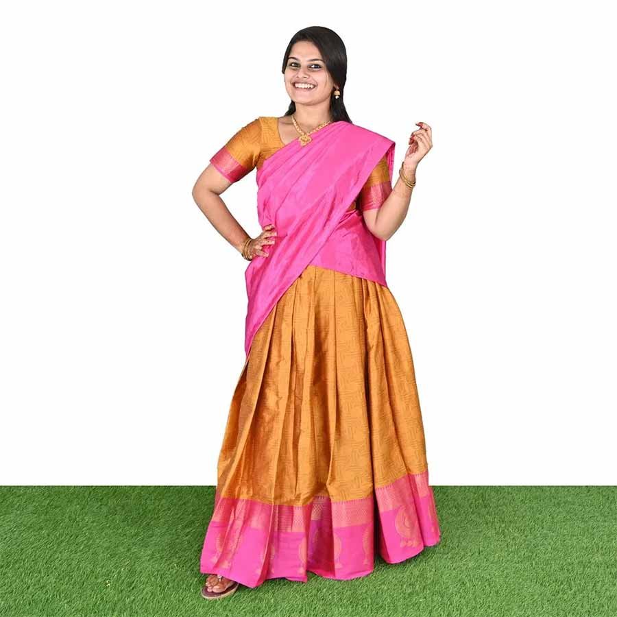 An ode to south Indian classic drapes. An exquisite half saree in a festive combination of hues. A versatile drape with an ethnic skirt and matching bodice teamed with a wispy vibrant dupatta that can be styled in multiple ways and have all eyes on you.