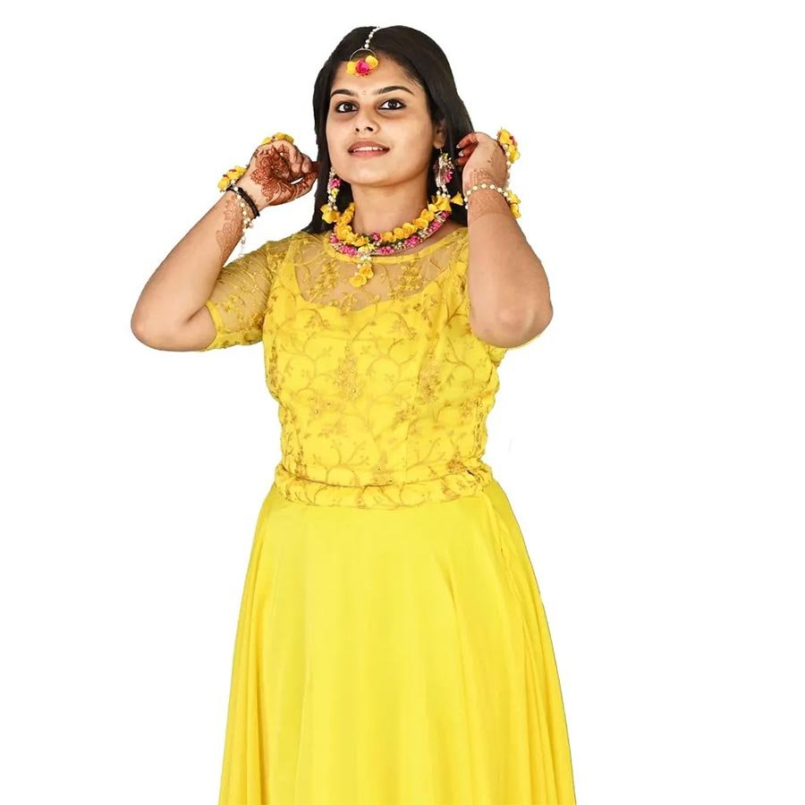A gorgeous lehenga immersed in haldi yellow. The crop top bodice with self embroidery features a sweet heart neckline complemented by its semi-sheer sleeves. The motifs of the top is mirrored in the waistband of the voluminous yellow skirt. A delicate assemblage that highlights your feminine side with subtlety and glamour.